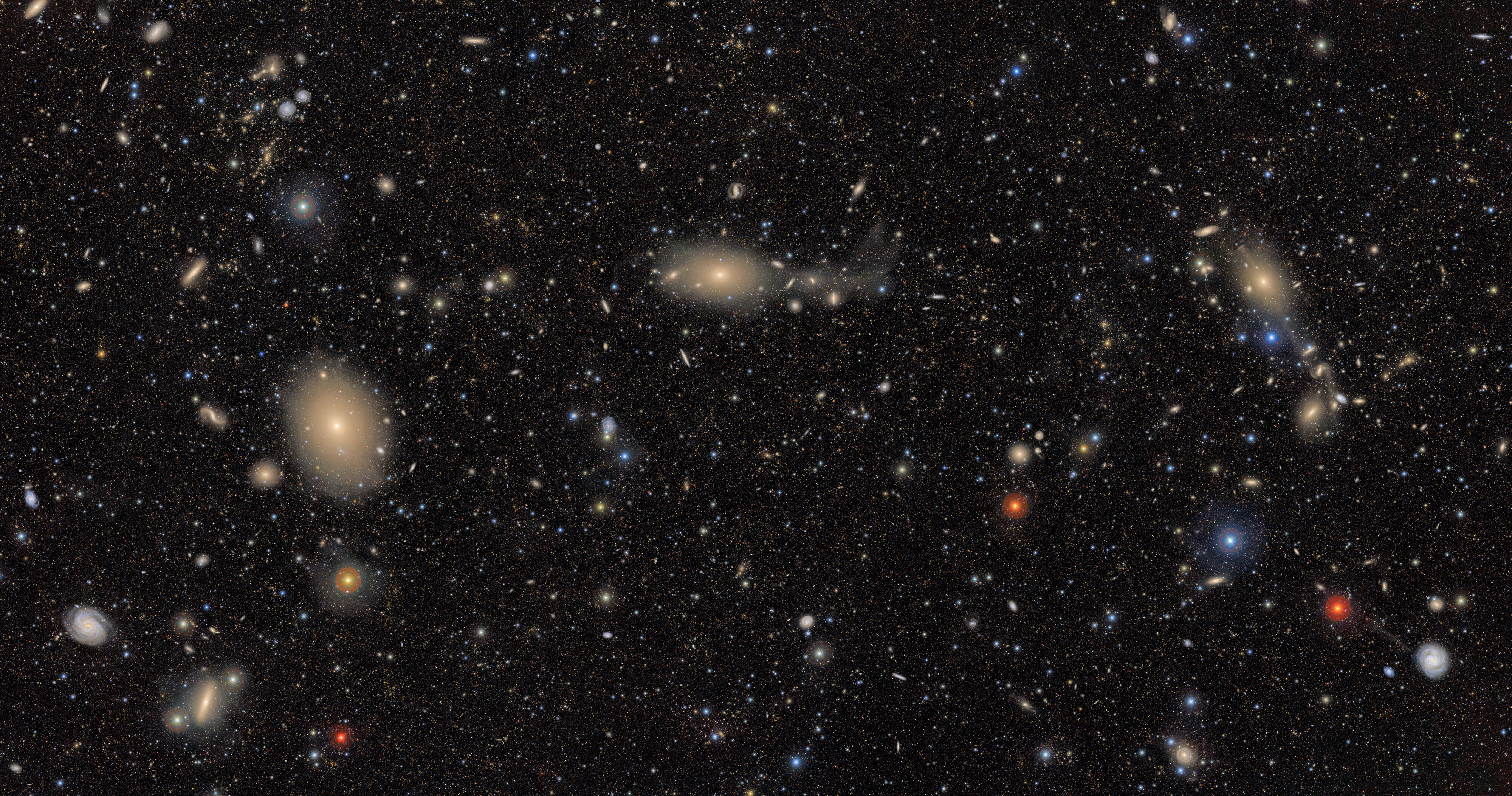 Hundreds of galaxies seen from a distance in space.