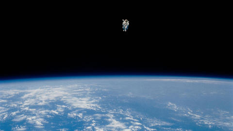 Solo astronaut in space above the Earth.