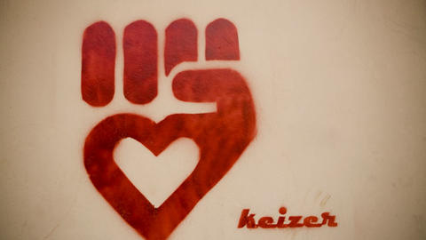 Graffiti graphic of a red fist with a heart in the middle