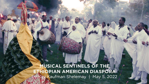 Ethiopian musicians playing instruments on a green field in Cambridge