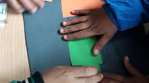 Image of student hands building a map
