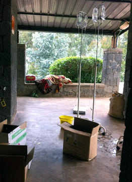 Image of family member napping near chemo prep area at Butaro