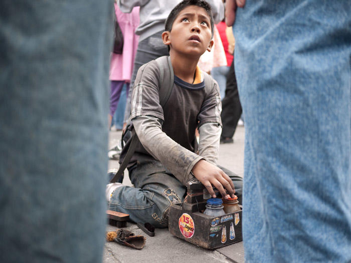 Image of young boy shining shoes