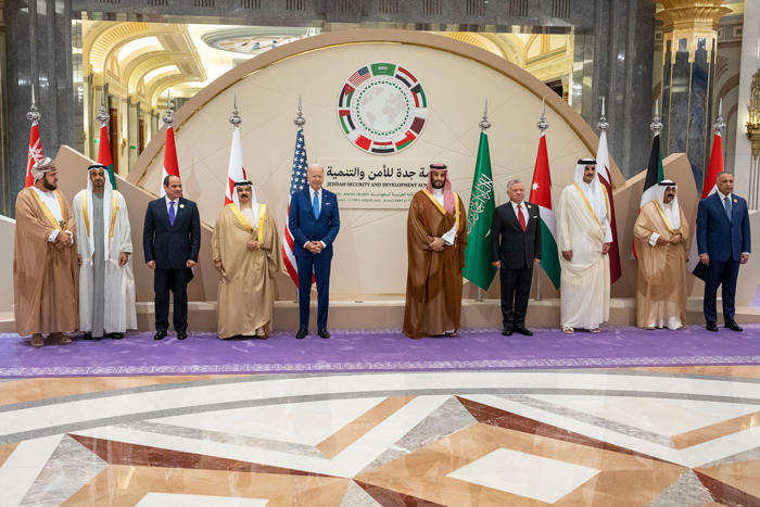 President Joe Biden stands on a stage with leaders of the GCC countries, Egypt, Iraq, and Jordan