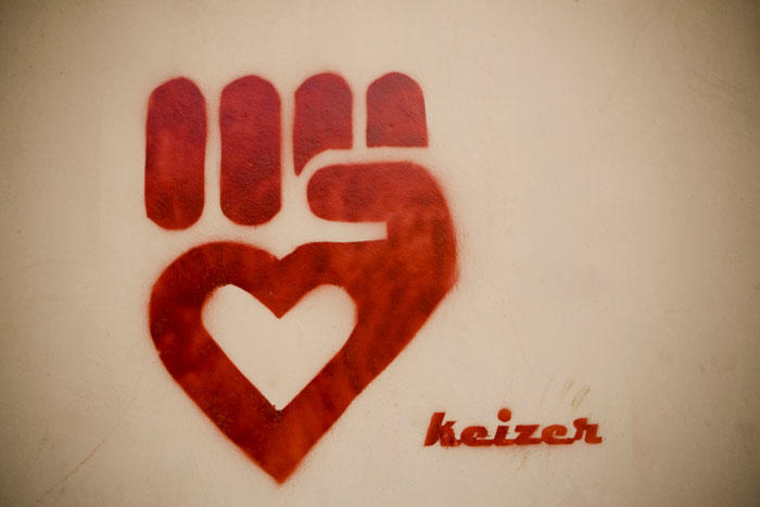 Graffiti graphic of a red fist with a heart in the middle