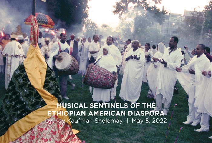 Ethiopian musicians playing instruments on a green field in Cambridge