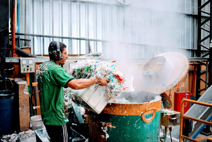Image of a man working at a plastics recycling plant in Brazil
