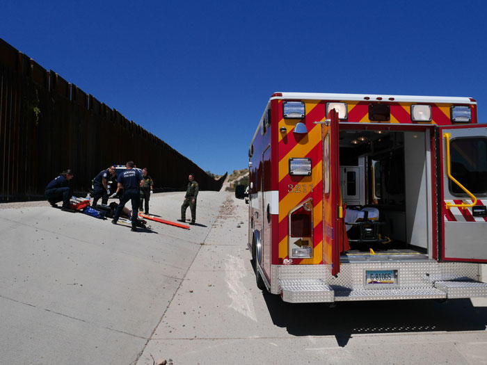 Image of emergency responders helping injured woman