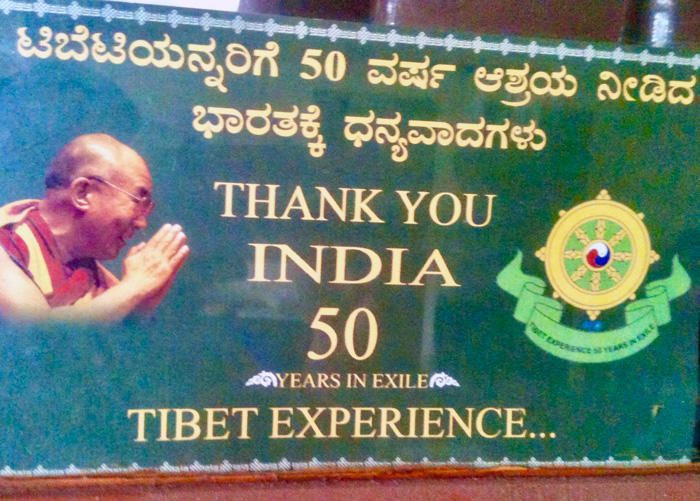 Image of billboard commemorating fifty years of exile in India from the Tibetan settlement at Bylakuppe, Karnataka in southern India