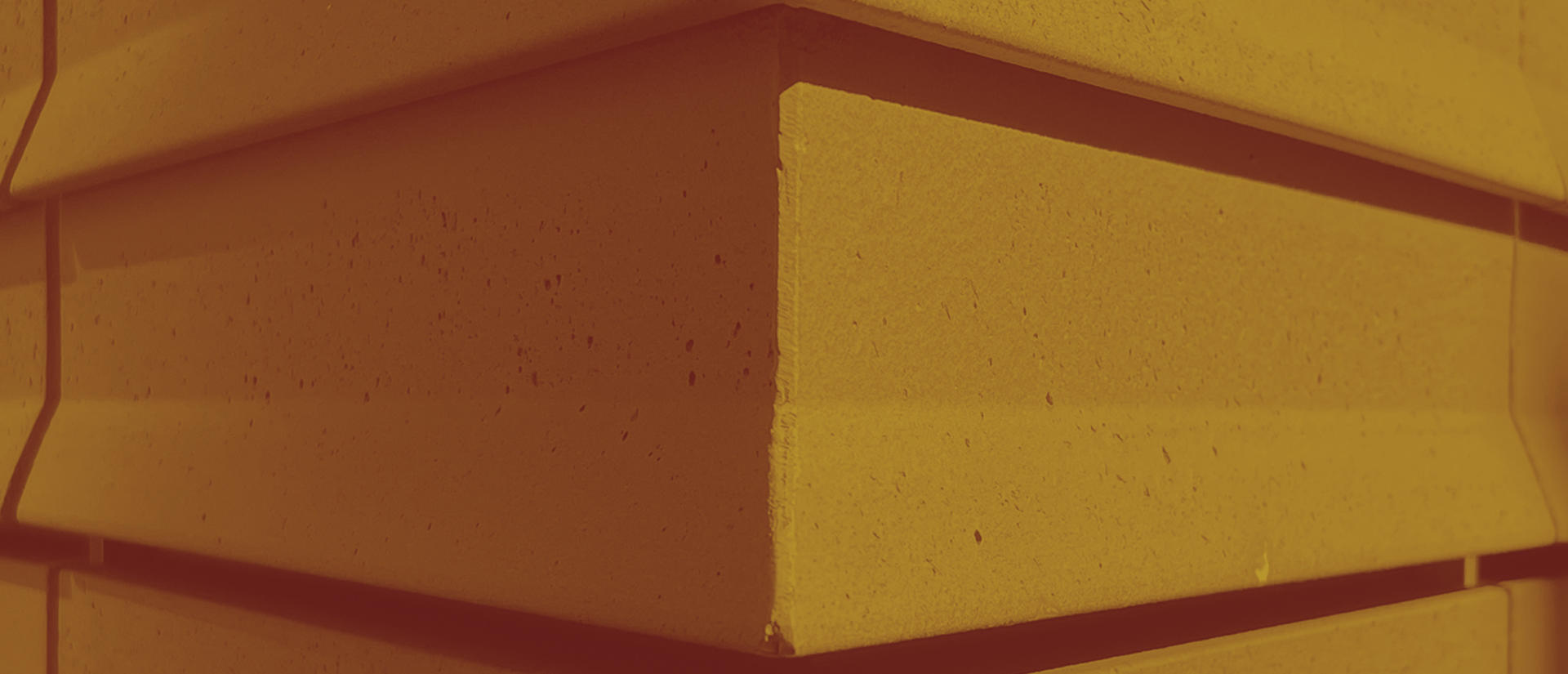 Two-toned gold and brown graphic of the angles on a building.